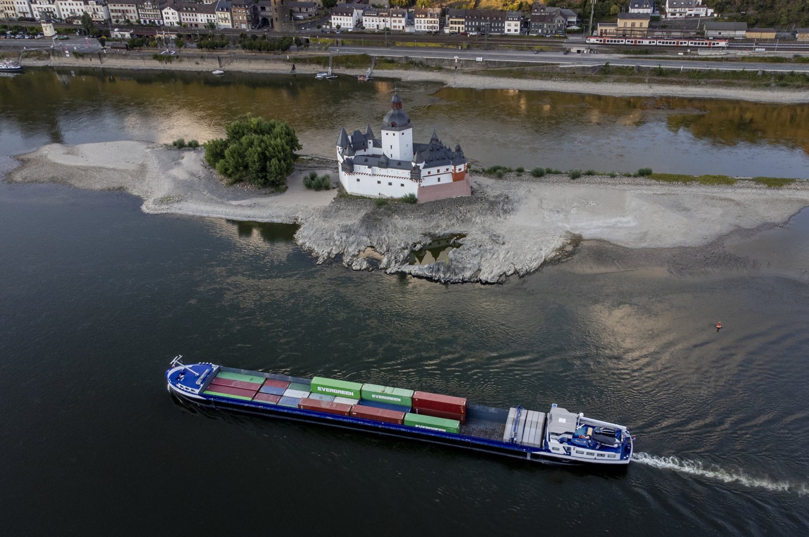A container ships passes Pfalzgrafenstein castle in the middle of the river Rhine in Kaub, Germany, Aug. 12, 2022. (AP Photo)