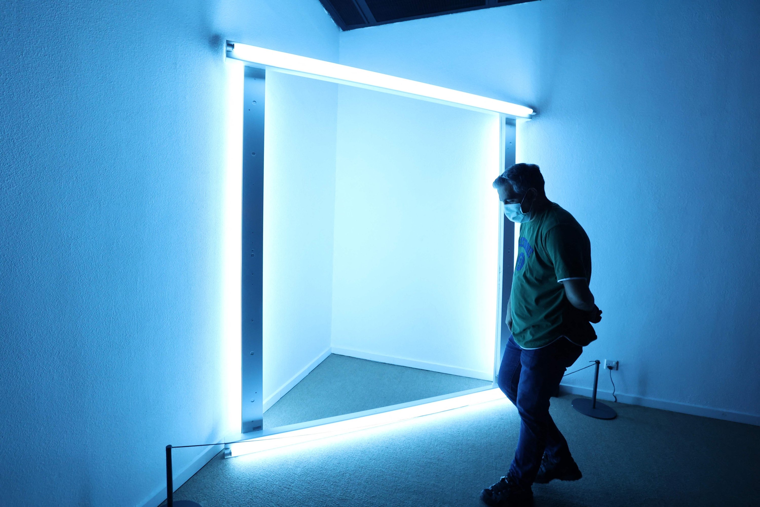 A visitor looks at an installation by American artist Dan Flavin during the 