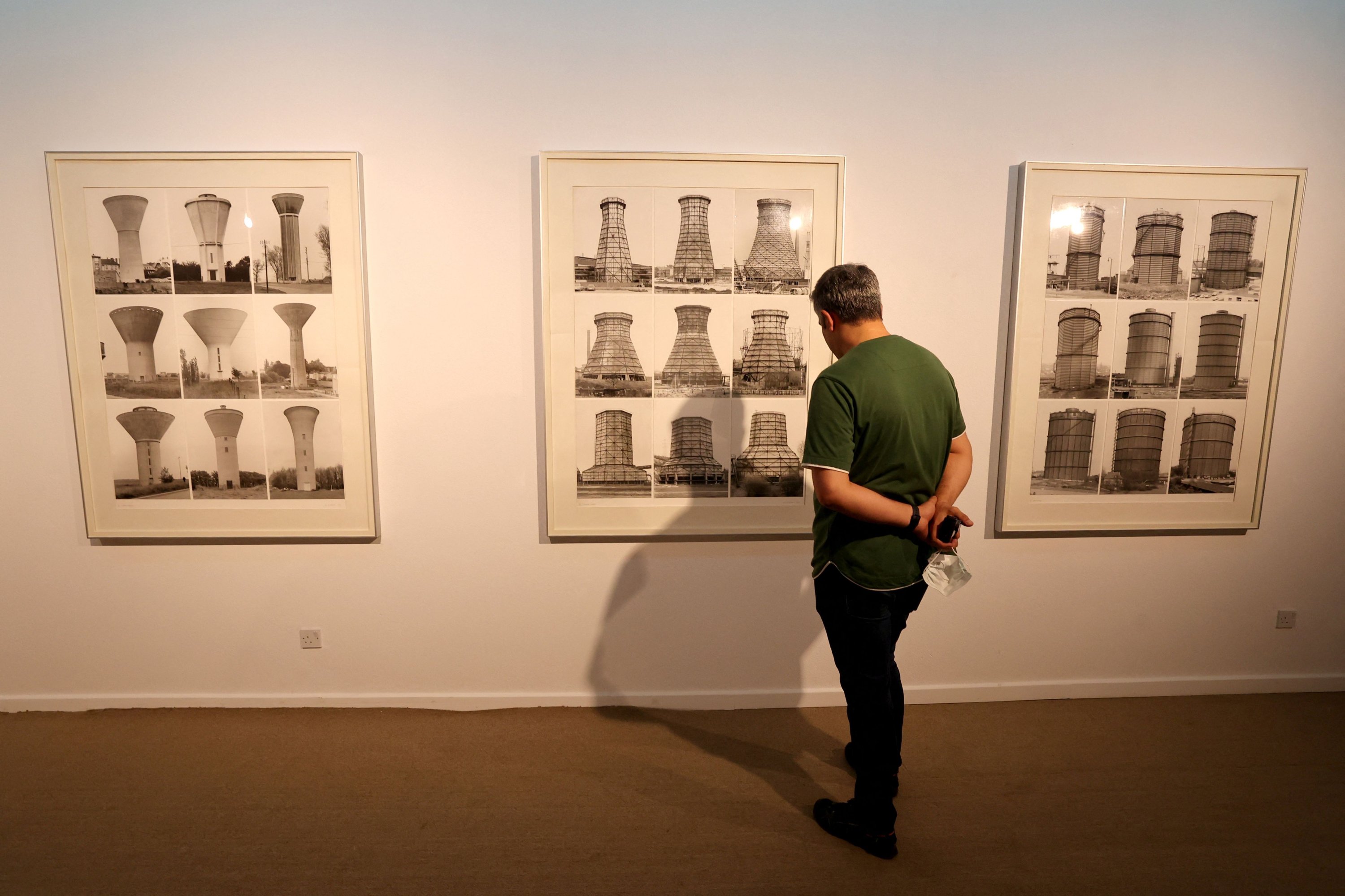 A visitor looks at works by German artists Bernd and Hilla Becher during the 