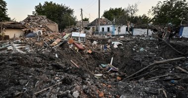 People stand next to a residential house destroyed by a Russian military strike in Chaplyne, Dnipropetrovsk region, Ukraine, Aug. 24, 2022. (Reuters Photo)