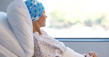 A young patient lies in a hospital bed. (Shutterstock Photo)