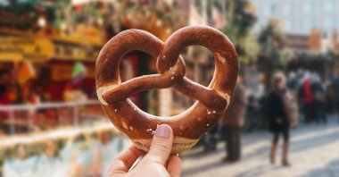 A girl holds a baked pretzel at a traditional Christmas market in Germany, Dec. 19, 2016. (Reuters File Photo)