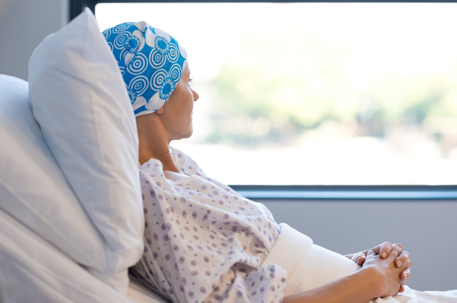 A young patient lies in a hospital bed. (Shutterstock Photo)