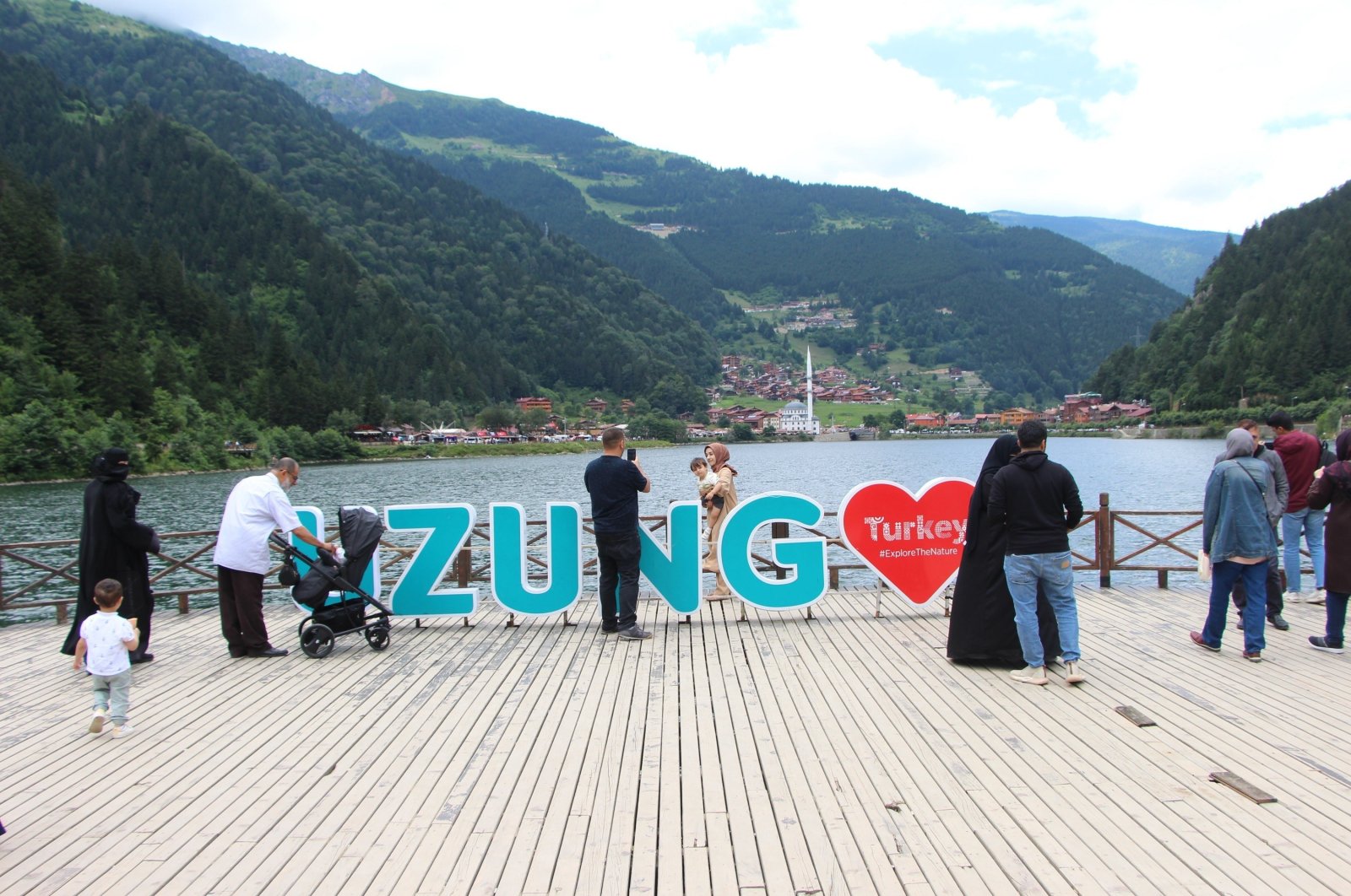 Locals and tourists enjoy the view at Uzungöl, a lake situated to the south of the city of Trabzon, northern Türkiye, Aug. 25, 2022. (IHA Photo)
