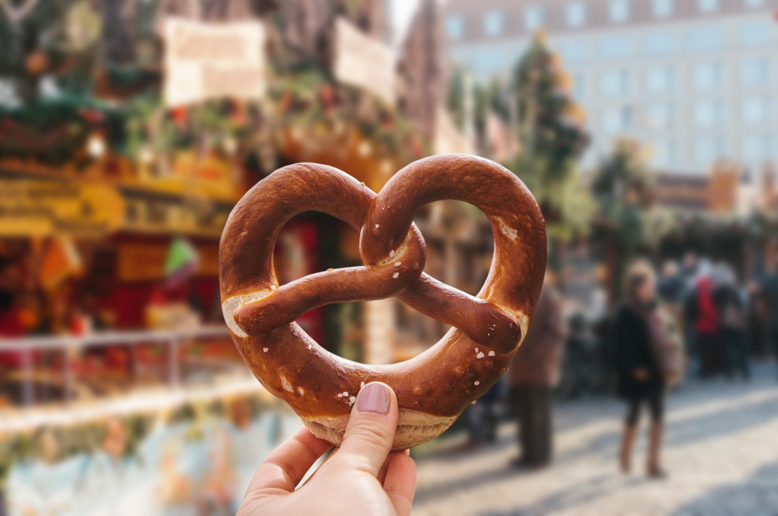 A girl holds a baked pretzel at a traditional Christmas market in Germany, Dec. 19, 2016. (Reuters File Photo)