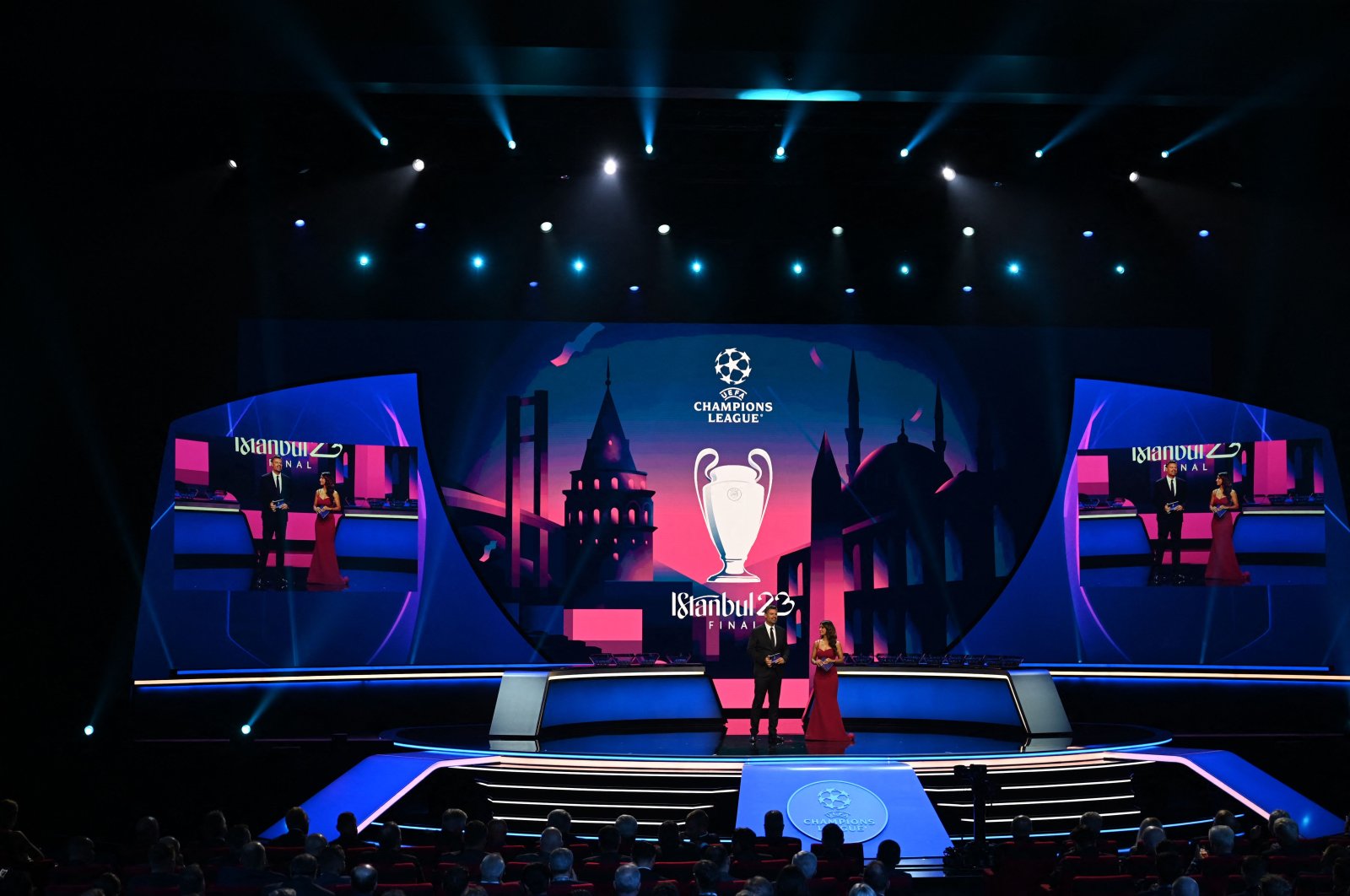 UEFA Managing Director of Communications Pedro Pinto (L) looks on next to British journalist Reshmin Chowdhury on stage during the draw ceremony for the 2022-2023 UEFA Champions League football tournament in Istanbul, Türkiye, Aug. 25, 2022. (AFP Photo)