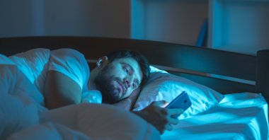 The bad habit of scrolling mindlessly on your smartphone before bed can lead to chronic sleep issues. (Shutterstock Photo)