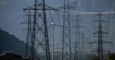 A wind turbine is surrounded by electricity pylons near Evionnaz, western Switzerland, Aug. 23, 2022. (AFP Photo)