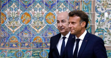 French President Emmanuel Macron (R) and Algeria's President Abdelmadjid Tebboune (L) leave at the end of a joint press conference at the presidential palace in Algiers, Algeria, Aug. 25, 2022. (AFP Photo)