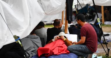 Refugees wait outside at the main reception centre for asylum seekers, in Ter Apel, Netherlands, Aug. 26, 2022. (Reuters Photo)