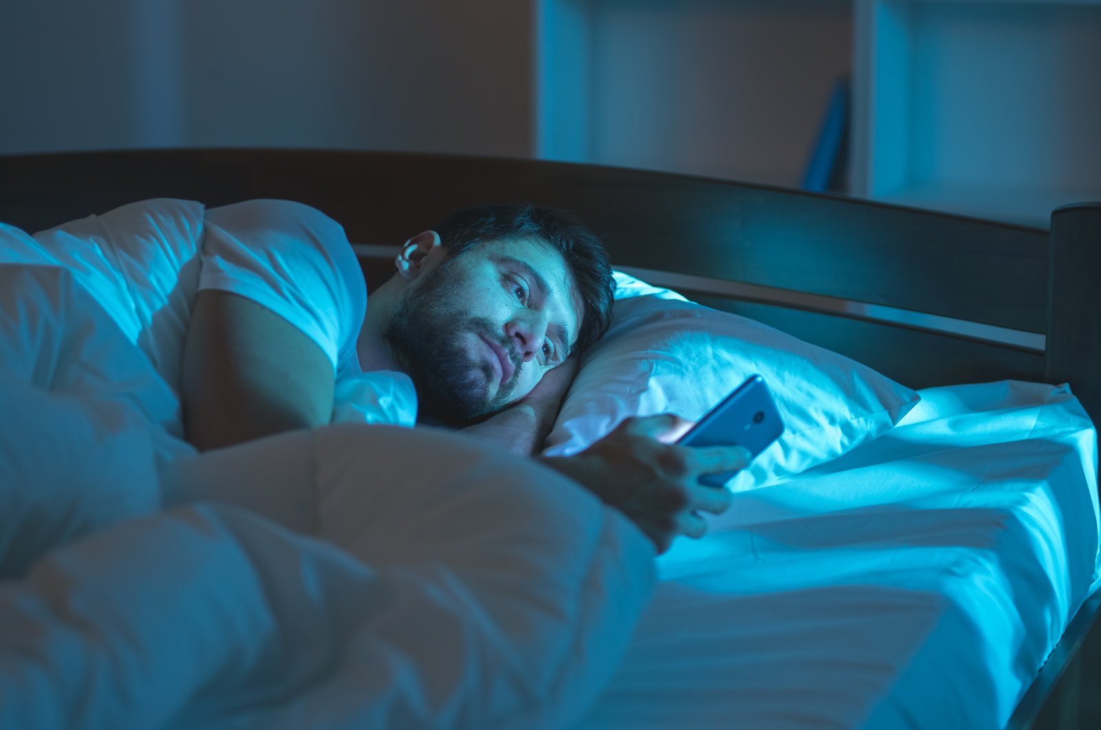 The bad habit of scrolling mindlessly on your smartphone before bed can lead to chronic sleep issues. (Shutterstock Photo)