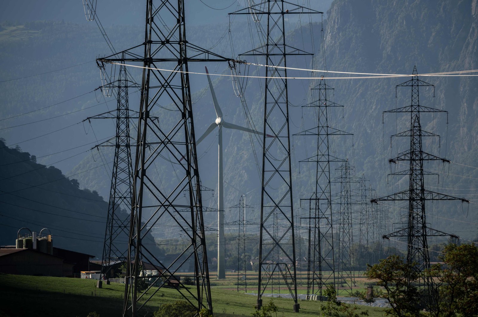 A wind turbine is surrounded by electricity pylons near Evionnaz, western Switzerland, Aug. 23, 2022. (AFP Photo)