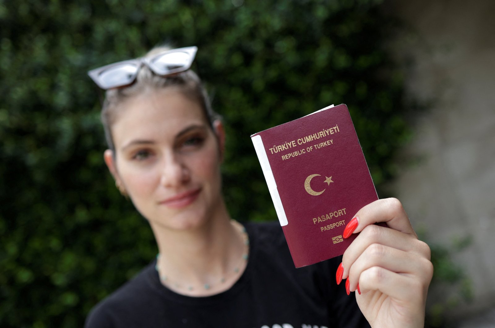 TV presenter Sinem Ökten holds her passport during an interview in Istanbul, Türkiye, Aug. 24, 2022. (Reuters Photo)