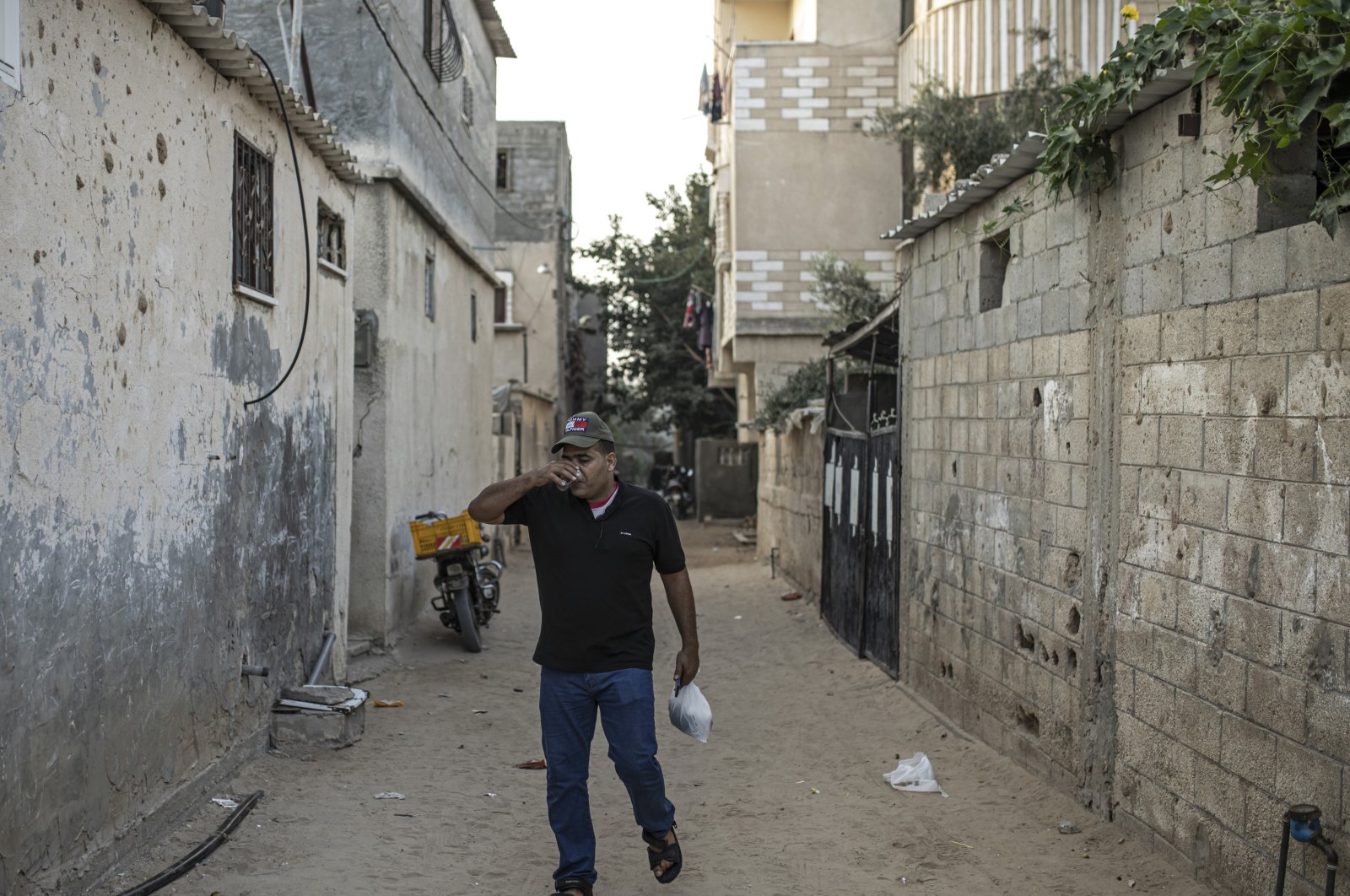 Palestinian Ibrahim Slaieh drinks coffee in the morning before crossing into Israel to work in Beersheba, in Khan Younis southern Gaza Strip, Aug. 21, 2022. (AP Photo)