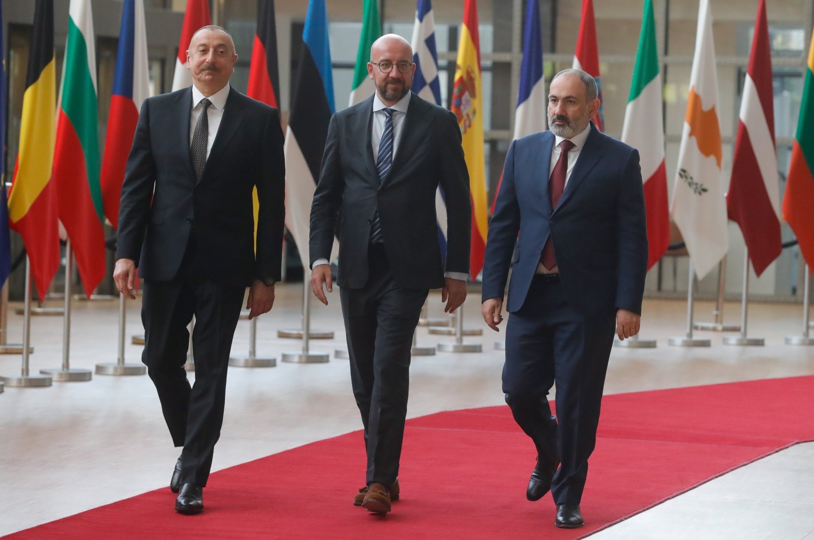 Azerbaijani President Ilham Aliyev (L) and Armenian Prime Minister Nikol Pashinian are welcomed by European Council President Charles Michel (C) in Brussels, Belgium, May 22, 2022. (EPA Photo)