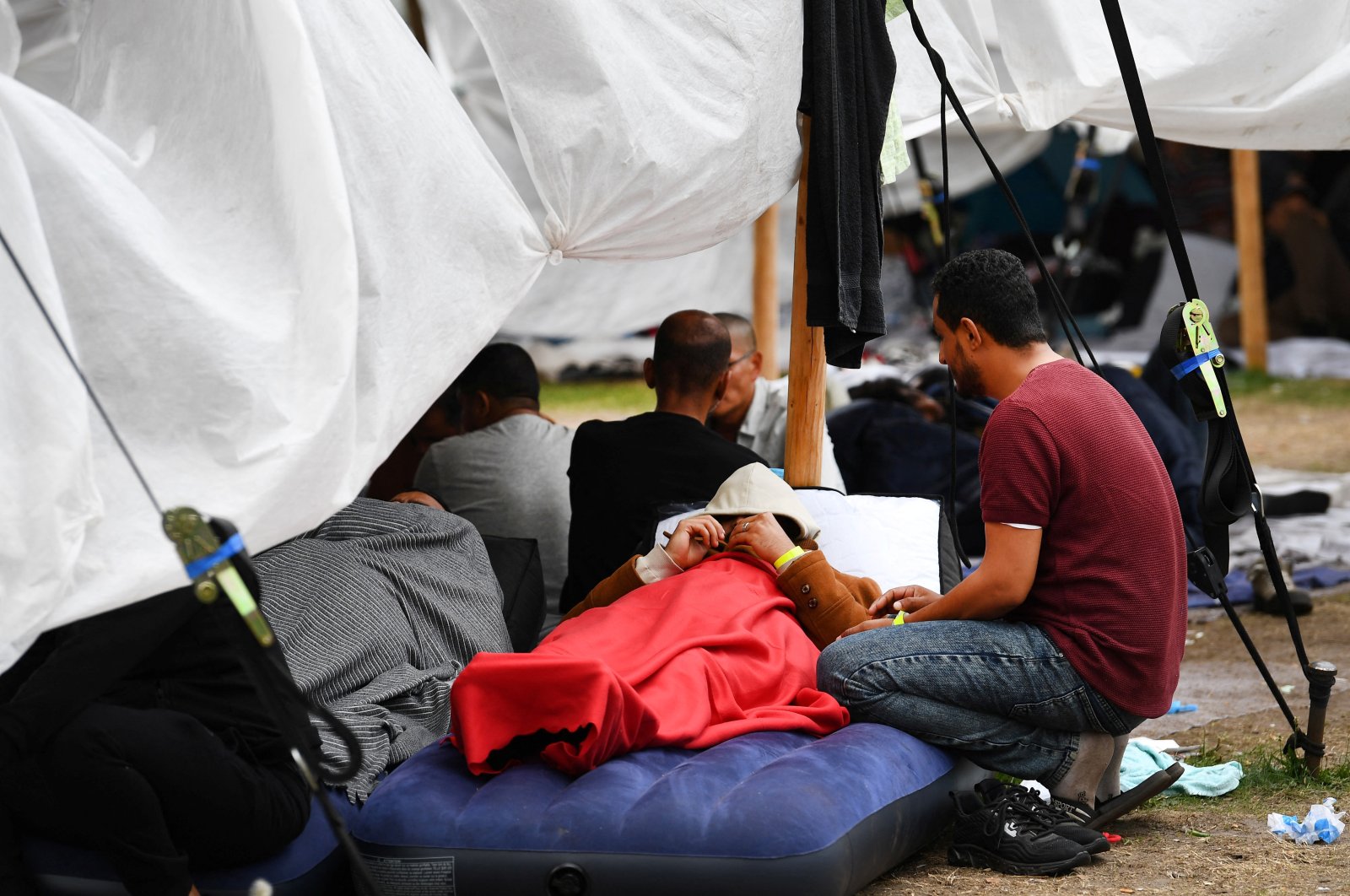 Refugees wait outside at the main reception centre for asylum seekers, in Ter Apel, Netherlands, Aug. 26, 2022. (Reuters Photo)