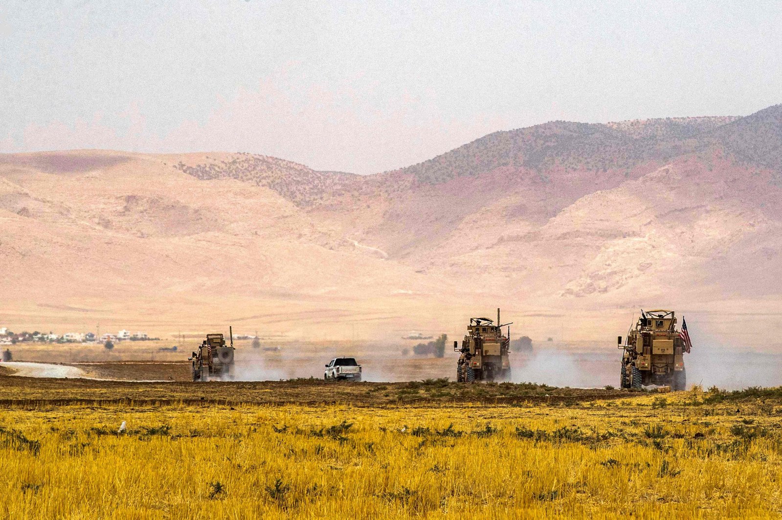 American military vehicles drive during a patrol near the Syrian-Turkish border, Aug. 21, 2022. (AFP)