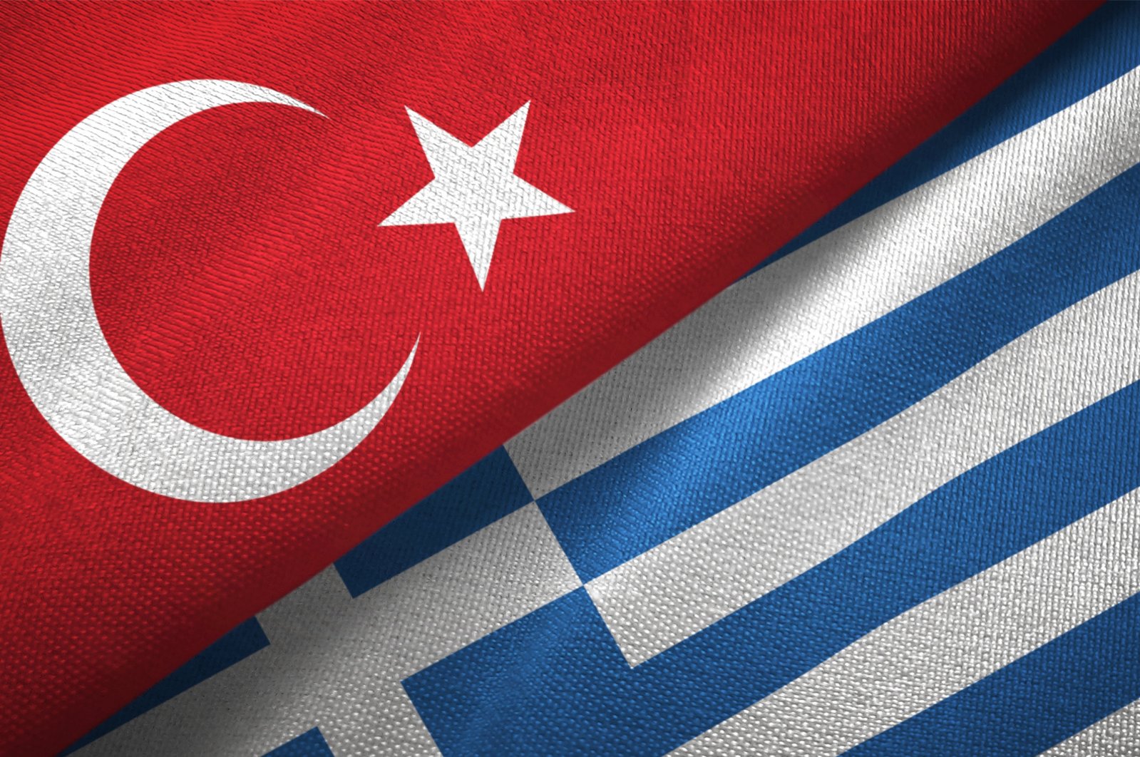 Turkish and Greek flags are seen in a textile cloth fabric texture, Sept. 6, 2020. (Getty Images)