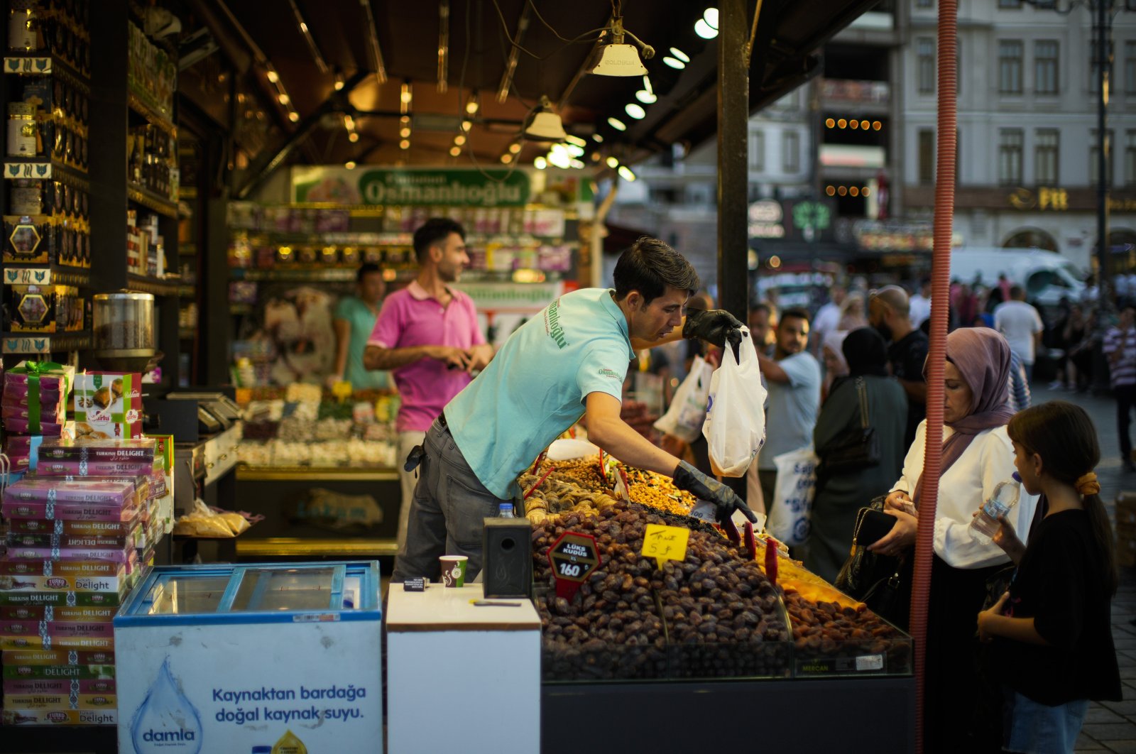 A clerk talks to a customer at a spices market in Istanbul, Türkiye, Aug. 18, 2022. (AP Photo)