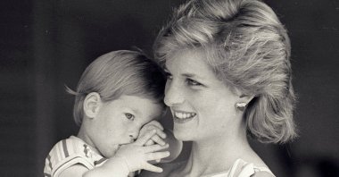In this file photo, young Prince Harry tries to hide behind his mother, Britain's Princess Diana, during a morning picture session at Marivent Palace, Spain, Aug. 9, 1988. (Reuters File Photo)