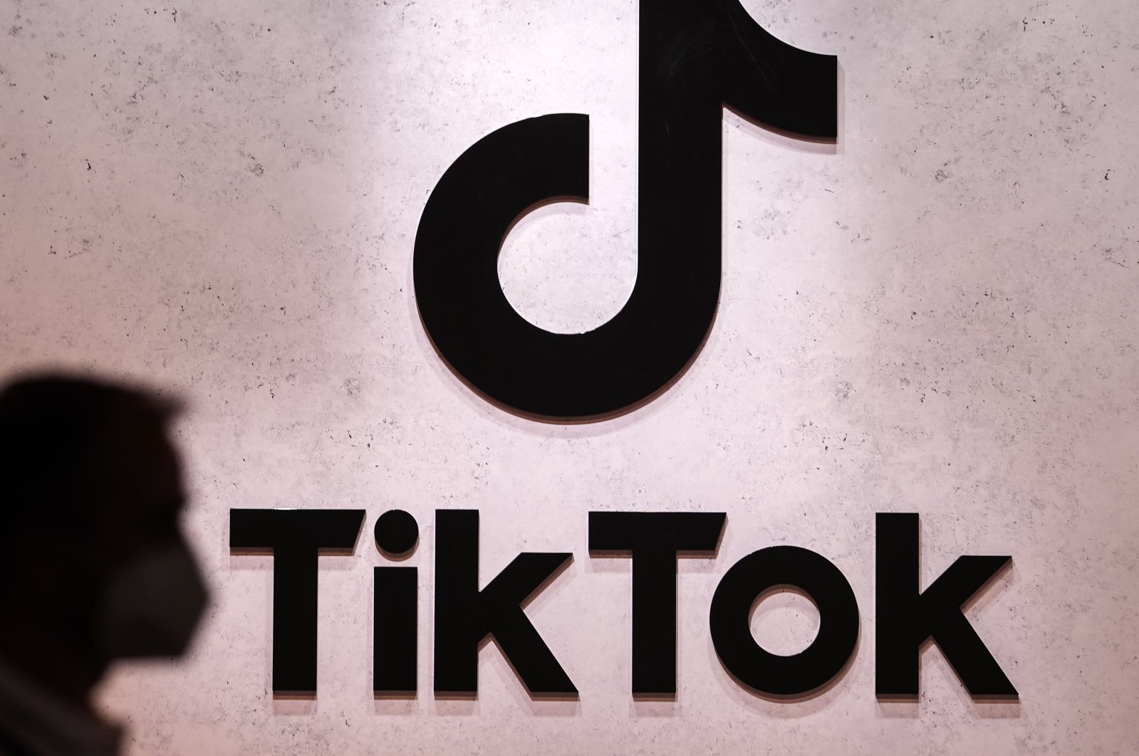 A visitor passes the TikTok exhibition stands at a fair in Cologne, Germany, Aug. 25, 2022. (AP Photo)