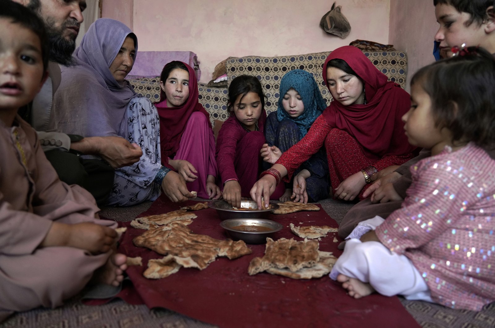 A family eat lunch in their home in one of Kabul&#039;s poor neighborhoods in Kabul, Afghanistan, May 21, 2022.(AP Photo)