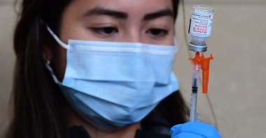 (FILES) In this file photo, the Moderna COVID-19 vaccine is being prepared for administration ahead of a free distribution of over the counter rapid COVID-19 test kits to people receiving their vaccines or boosters at Union Station in Los Angeles, U.S., Jan. 7, 2022. (Photo by Frederic J. BROWN / AFP)