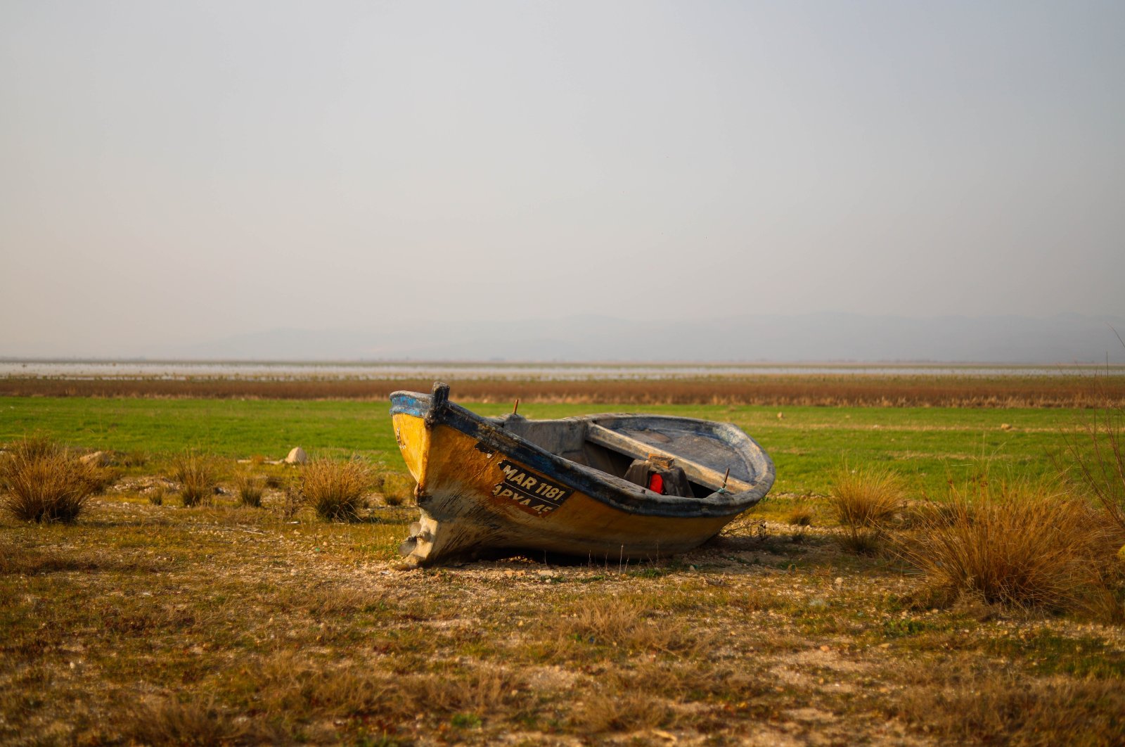 A boat lies on a dried part of Lake Marmara, in Manisa, western Türkiye, Aug. 9, 2022. (İHA PHOTO)