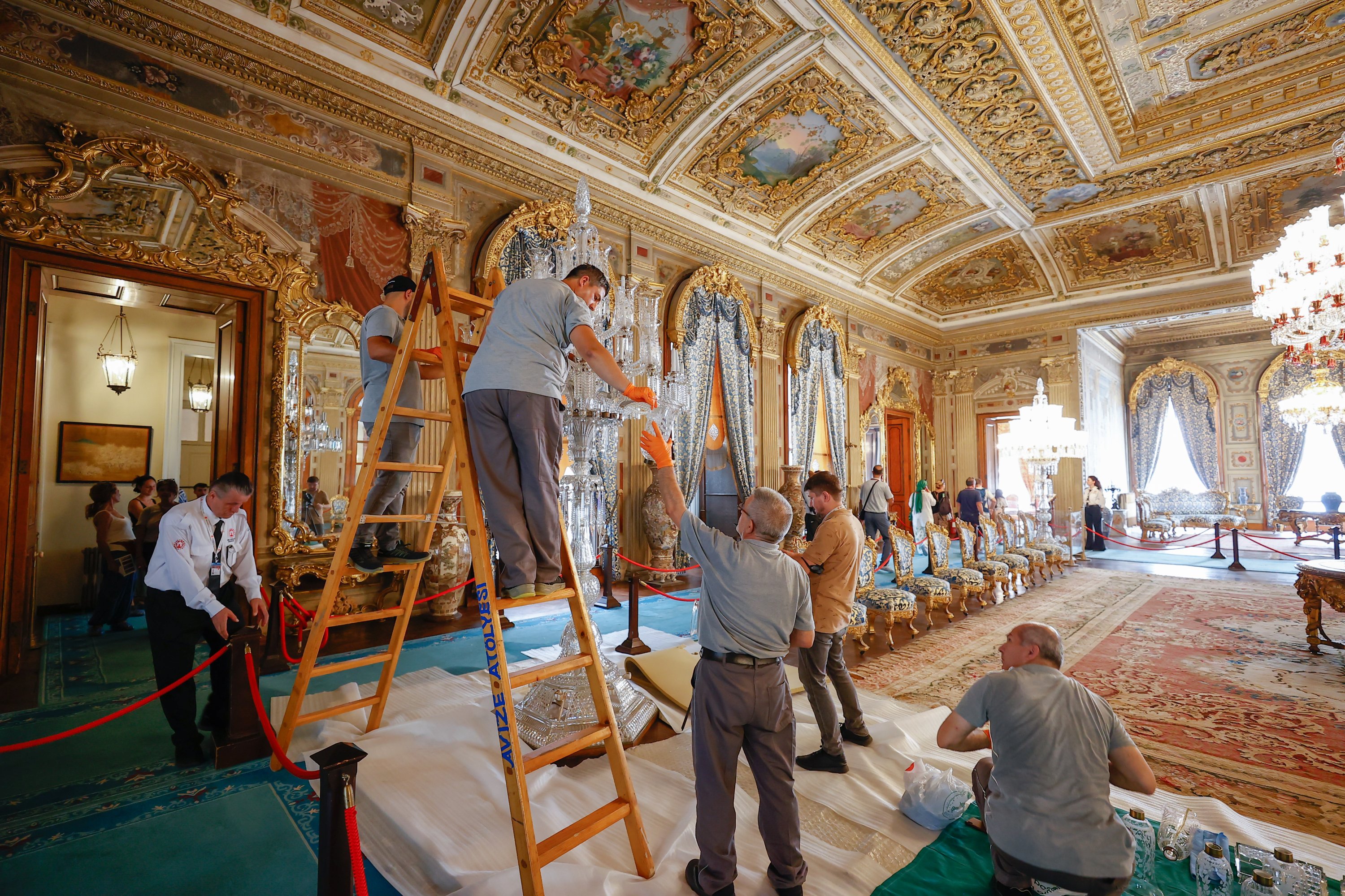 Para ahli mengerjakan lampu gantung di Istana Dolmabahçe, Istanbul, Türkiye, 2 September 2022. (AA Photo)