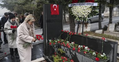 Şengül Hablemitoğlu leaves flowers at her husband Necip Hablemitoğlu&#039;s grave in the capital Ankara, Türkiye, Dec. 19, 2019. (AA PHOTO) 