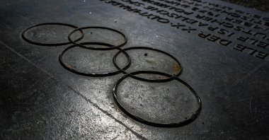 A commemorative plaque with the Olympic Rings in front of the Memorial to the Victims of the 1972 Olympic Attack at the Olympic Park in Munich, Germany, Aug. 17, 2022. (AFP Photo)