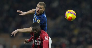 Inter's Edin Dzeko (L) vies with Milan's Fikayo Tomori during an Italian Cup semifinal match, Milan, Italy, March 1, 2022. (AP Photo)