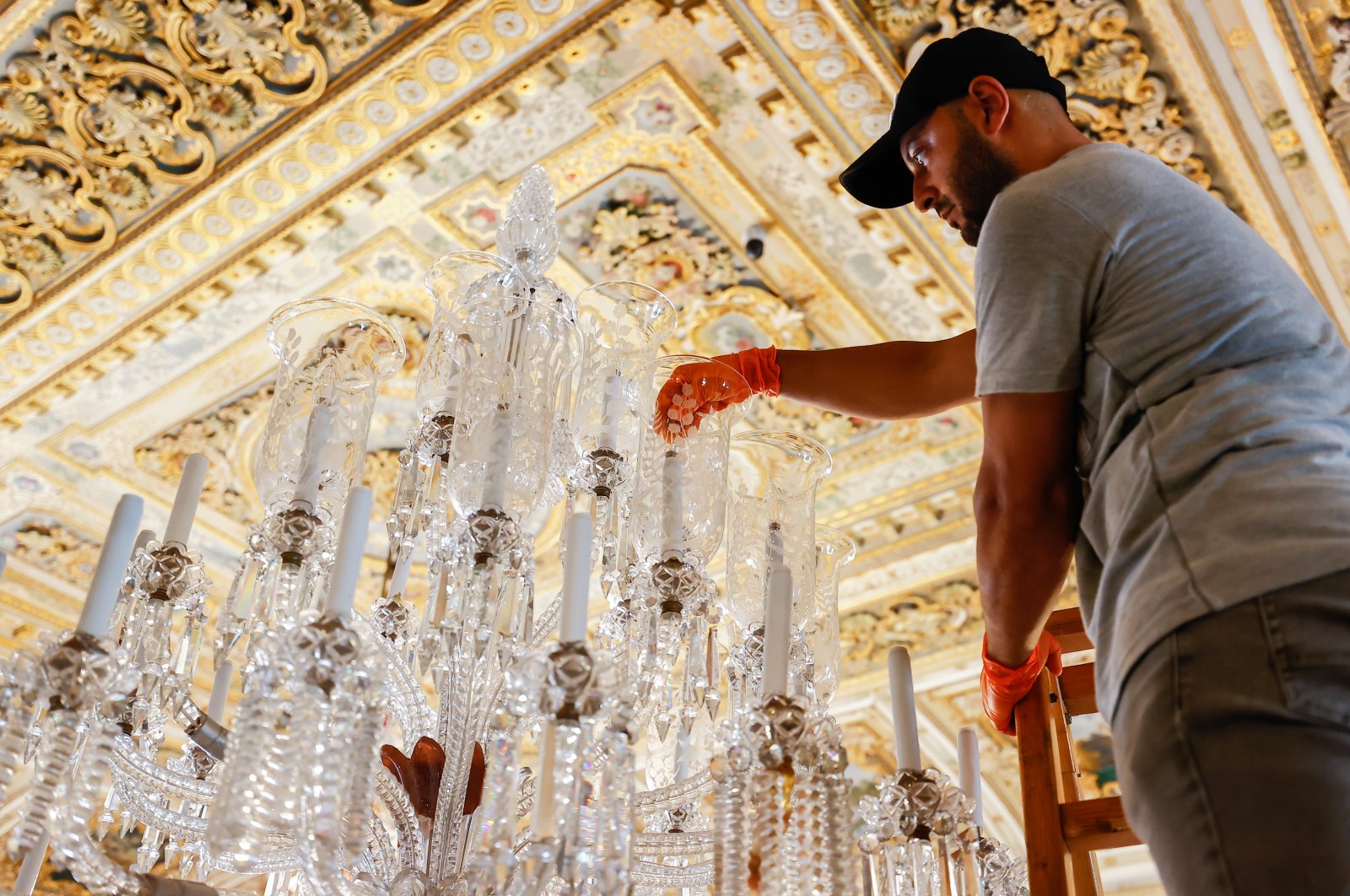 An expert works on a chandelier at Dolmabahçe Palace, Istanbul, Türkiye, Sept. 2, 2022. (AA Photo)