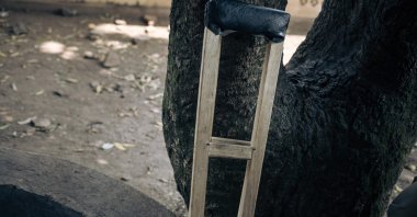 A wooden crutch used by a young militiaman with a gunshot wound to the leg is seen against a tree at Rutshuru Hospital in the eastern province of North Kivu, Democratic Republic of Congo, July 23, 2022. (AFP Photo)