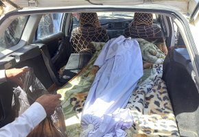 The covered body of a girl lies in the back of a vehicle after she was killed by an unexploded shell in Helmand province, southern Afghanistan, Sept. 3, 2022. (AP Photo/Abdul Khaliq)