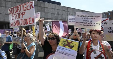 Participants protest at a pro-Russian rally under the slogan "Against war and arms supplies to Ukraine" in Cologne, Germany, Sunday, Sept. 4, 2022. (Roberto Pfeil/dpa via AP)