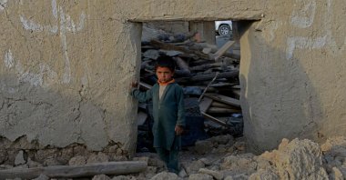 A boy stands inside a damaged house after a recent earthquake at Akhtar Jan village in Gayan district of Paktika province, Afghanistan, June 25, 2022. (AFP Photo)