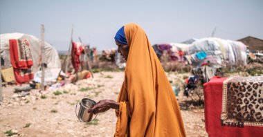 Yurub Abdi Jama, a 35-year-old mother of eight children, walks while holding a cup in an informal settlement of internally displaced people in the outskirts of the city of Hargeisa, Somaliland, Somalia, Sept. 16, 2021. (AFP File Photo)