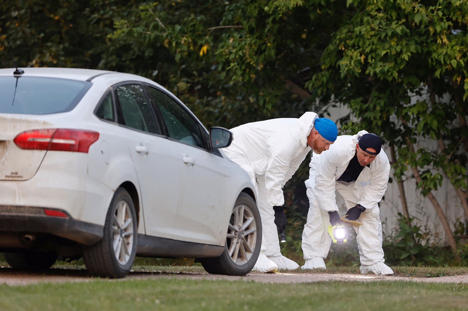 A police forensics team investigates a crime scene after multiple people were killed and injured in a stabbing spree in Weldon, Saskatchewan, Canada, Sept. 4, 2022. (Reuters Photo)