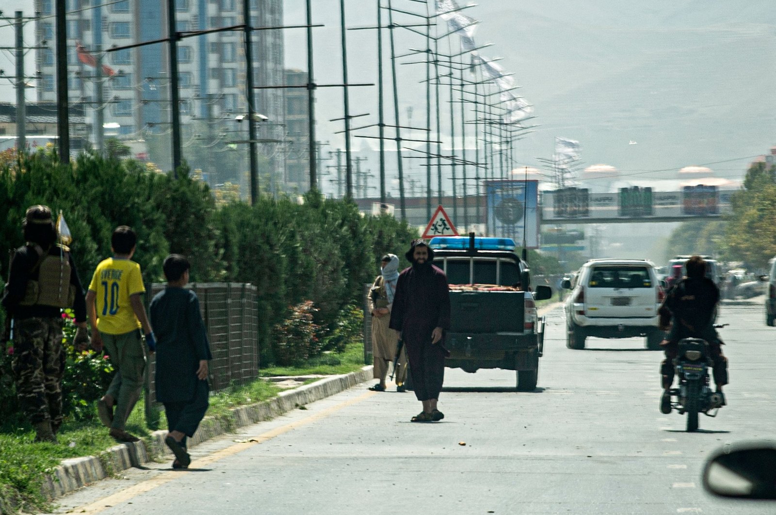 Taliban fighters (C) stand guard along a road near the Russian Embassy after a suicide attack in Kabul, Afghanistan, Sept. 5, 2022. (AFP Photo)