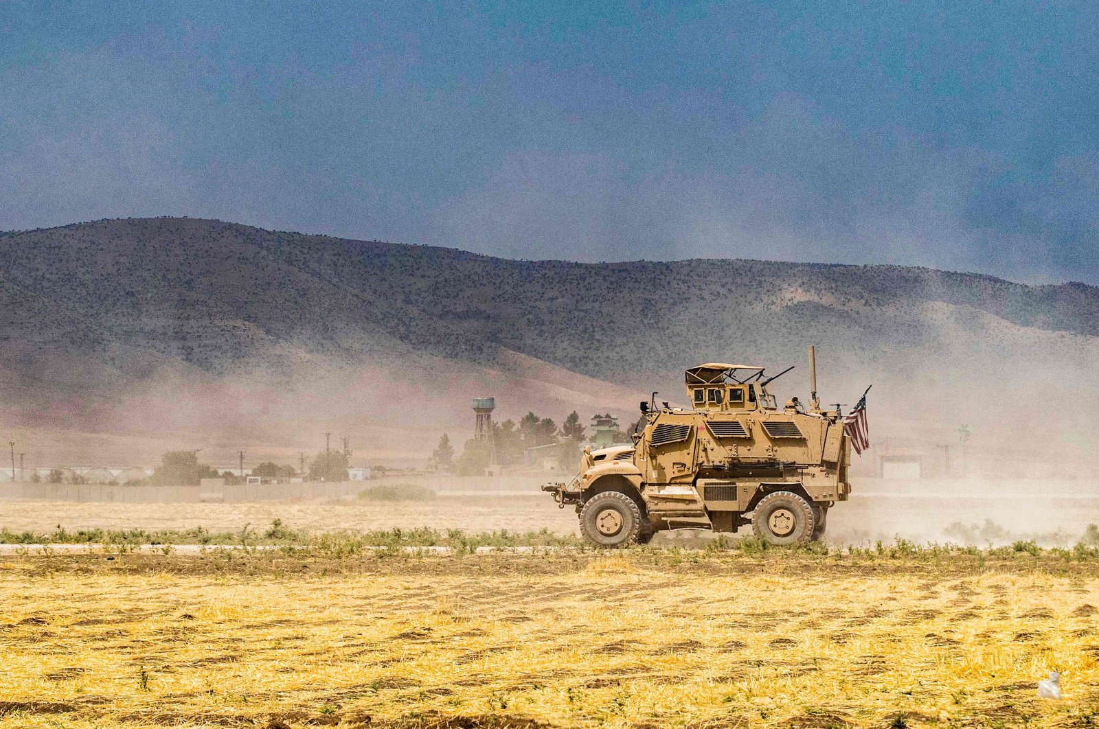 A U.S. Oshkosh M-ATV Mine Resistant Ambush Protected (MRAP) military vehicle drives during a patrol near the Syrian-Turkish border, east of Qamishli, Syria, Aug. 21, 2022. (AFP Photo)