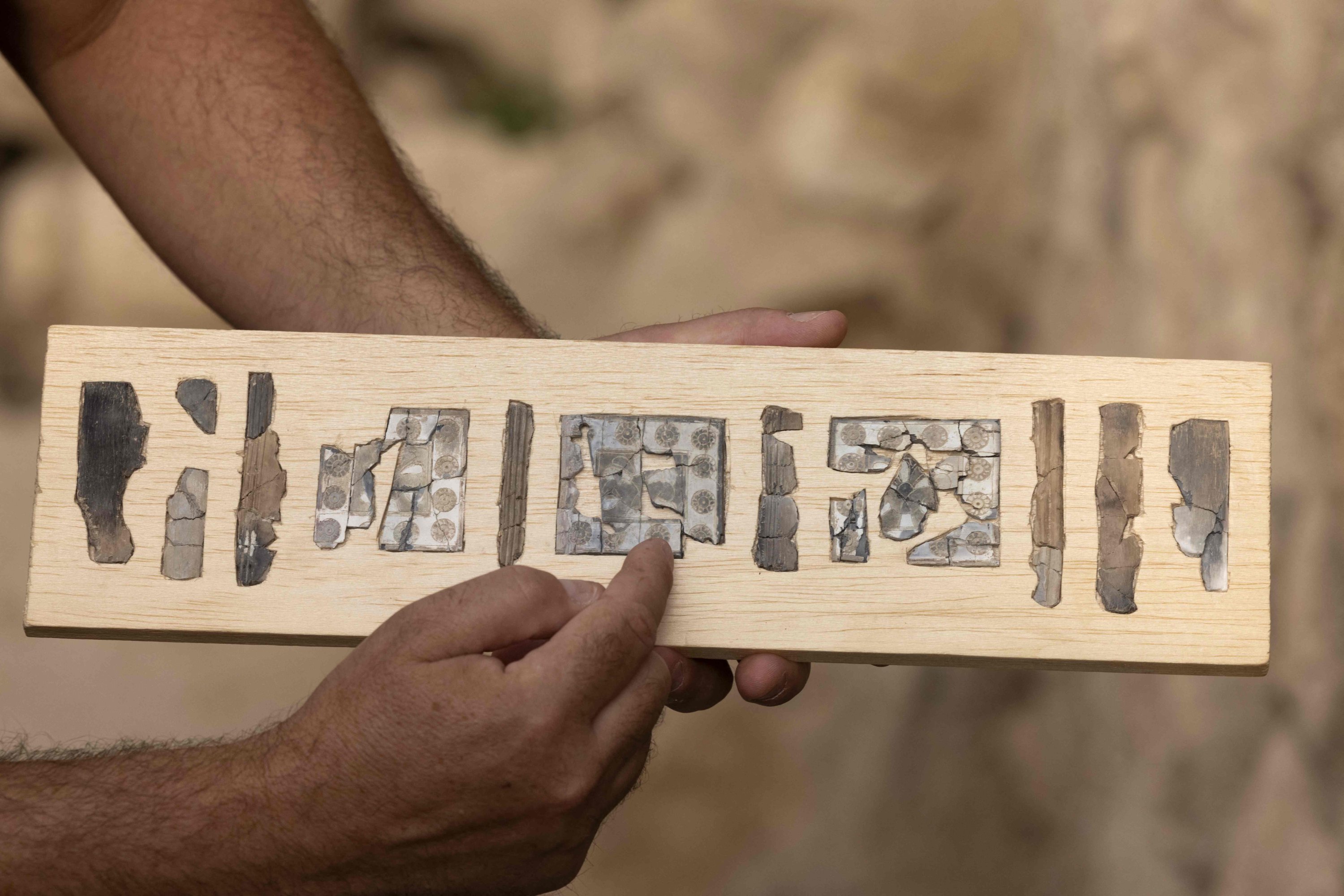 Yiftah Shalev displays ivory plaques unearthed in excavations in the Givati Parking Lot in the City of David National Park near the walls of the Old City of East Jerusalem, occupied Palestine, Sept. 5, 2022. (AFP Photo)