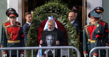 Nobel Peace Prize laureate journalist Dmitry Muratov carries a picture of late former Soviet President Mikhail Gorbachev after a farewell ceremony at the House of Trade Unions in Moscow, Russia, Sept. 3, 2022. (EPA Photo)