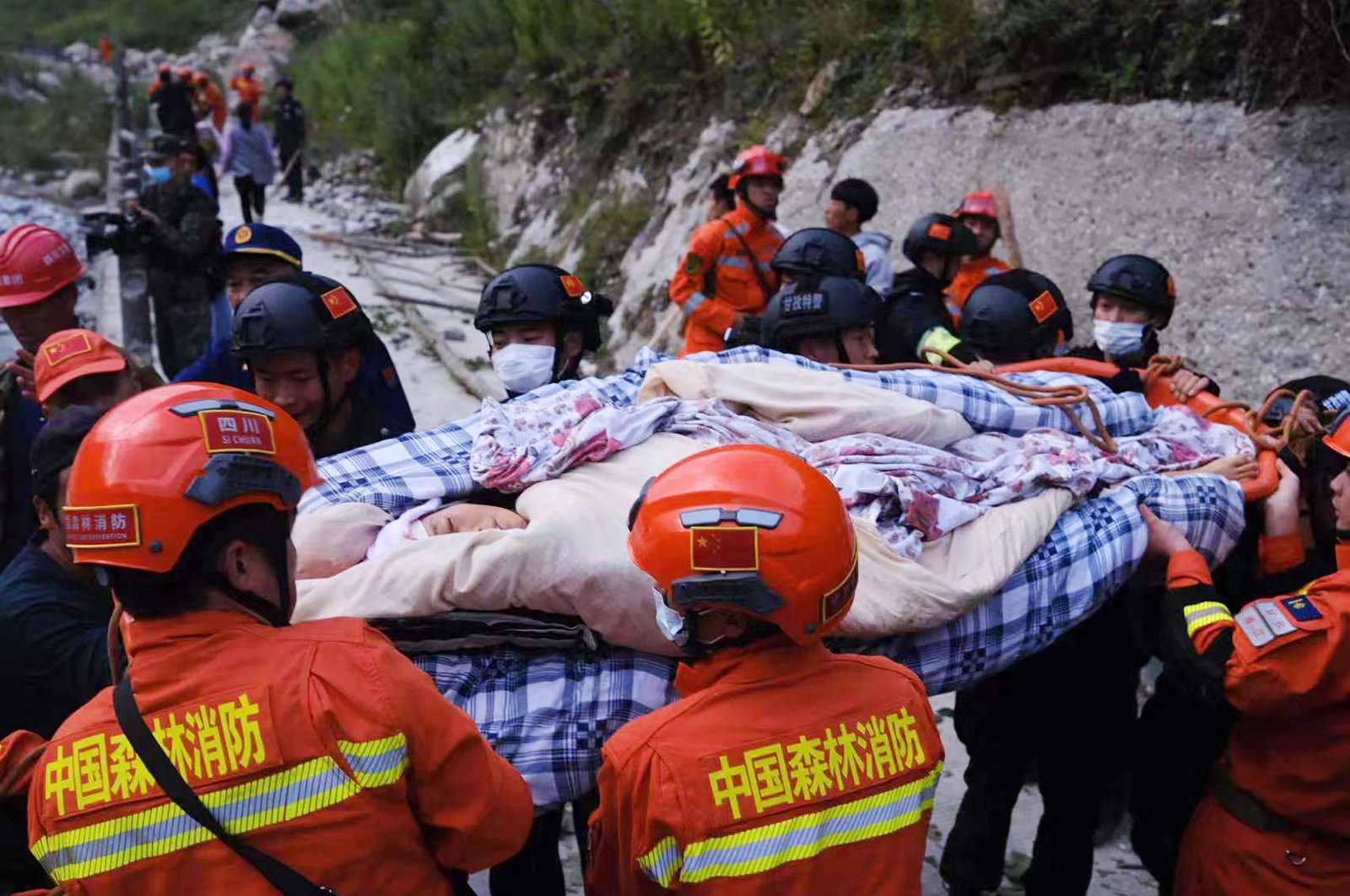 Rescue workers carry an injured person after a 6.6 magnitude earthquake in Luding county, Ganzi, Sichuan province, China, Sept. 5, 2022. (AFP Photo)