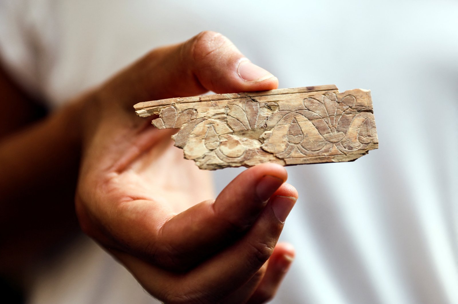 A worker holds an ivory plaque unearthed in excavations near the walls of Jerusalem&#039;s Old City, East Jerusalem, occupied Palestine, Sept. 5, 2022. (Reuters Photo)