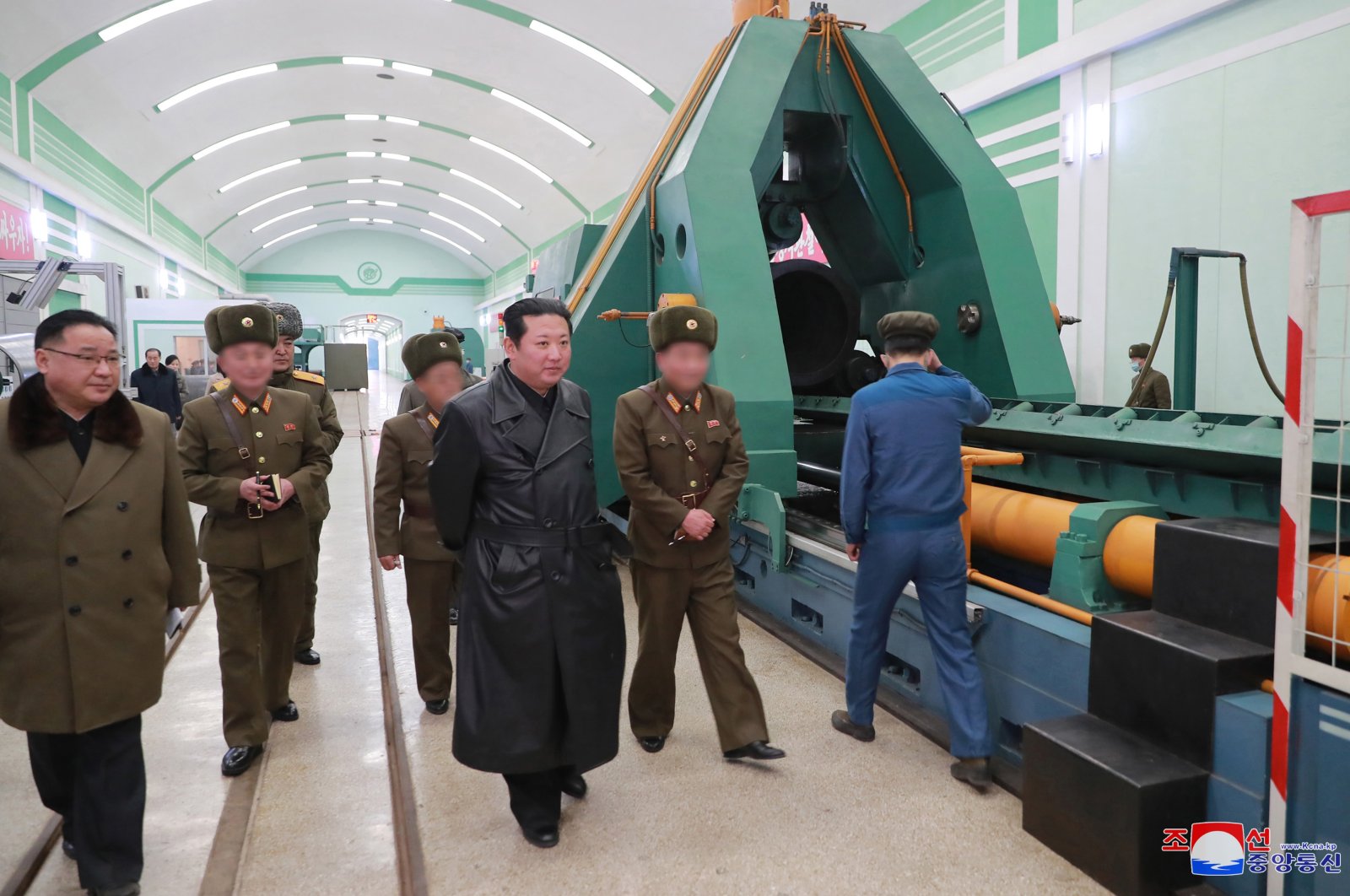 Chairperson of the North Korean State Affairs Committee, Kim Jong Un (C), during a visit to a munitions factory in the country that produces an &quot;important weapons system&quot; days after North Korea conducted tests to reveal its new missiles in this photo released on Jan. 28, 2022. (Reuters File Photo)