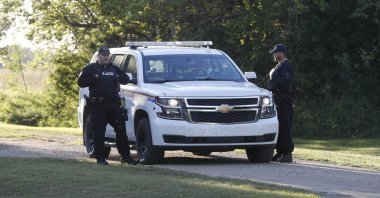 Royal Canadian Mounted Police officers stand next to a police vehicle outside the house where one of the stabbing victims was found in Weldon, Saskatchewan, Canada, Sept. 6, 2022. (AFP Photo)