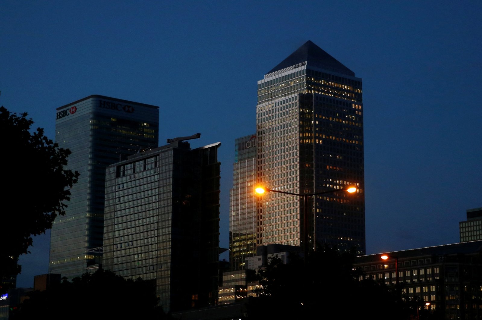 Office lights are on in banks as dawn breaks behind the financial district of Canary Wharf, in London, Britain, June 24, 2016. (Reuters Photo)