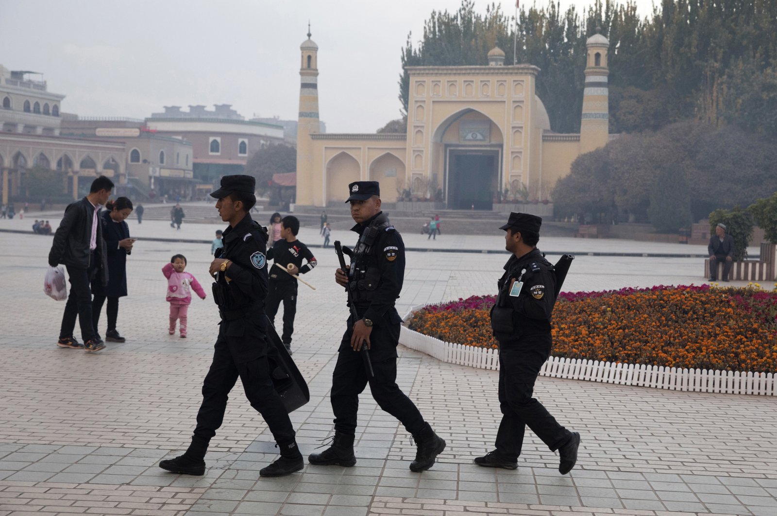 Uyghur security personnel patrol near the Id Kah Mosque in Kashgar in western China&#039;s Xinjiang region, Nov. 4, 2017. (AP Photo)