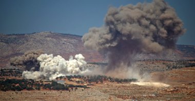 Plumes of smoke rise during reported Russian bombing near the village of Hafsarja, in the western countryside of Idlib, Syria, Sept. 8, 2022. (AFP Photo)